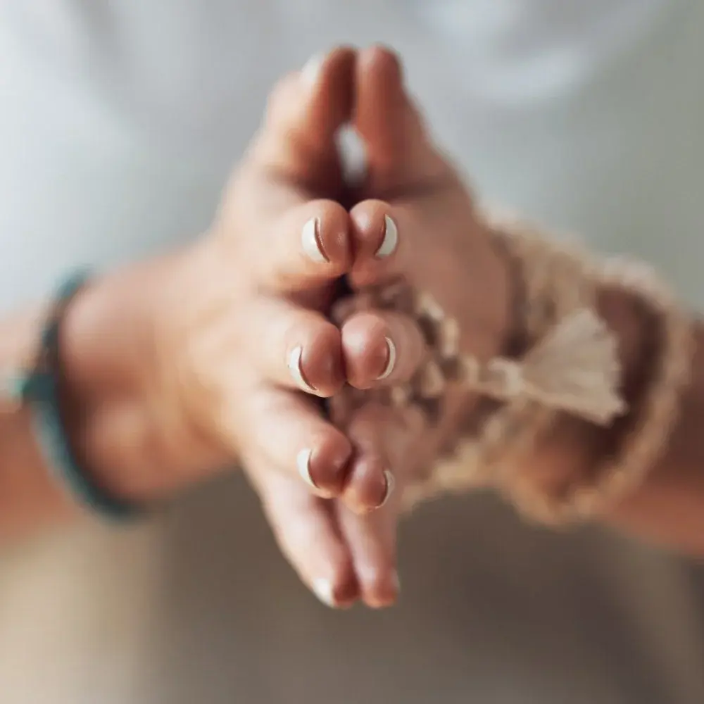 Close-up of hands resting in a calm breathing exercise position